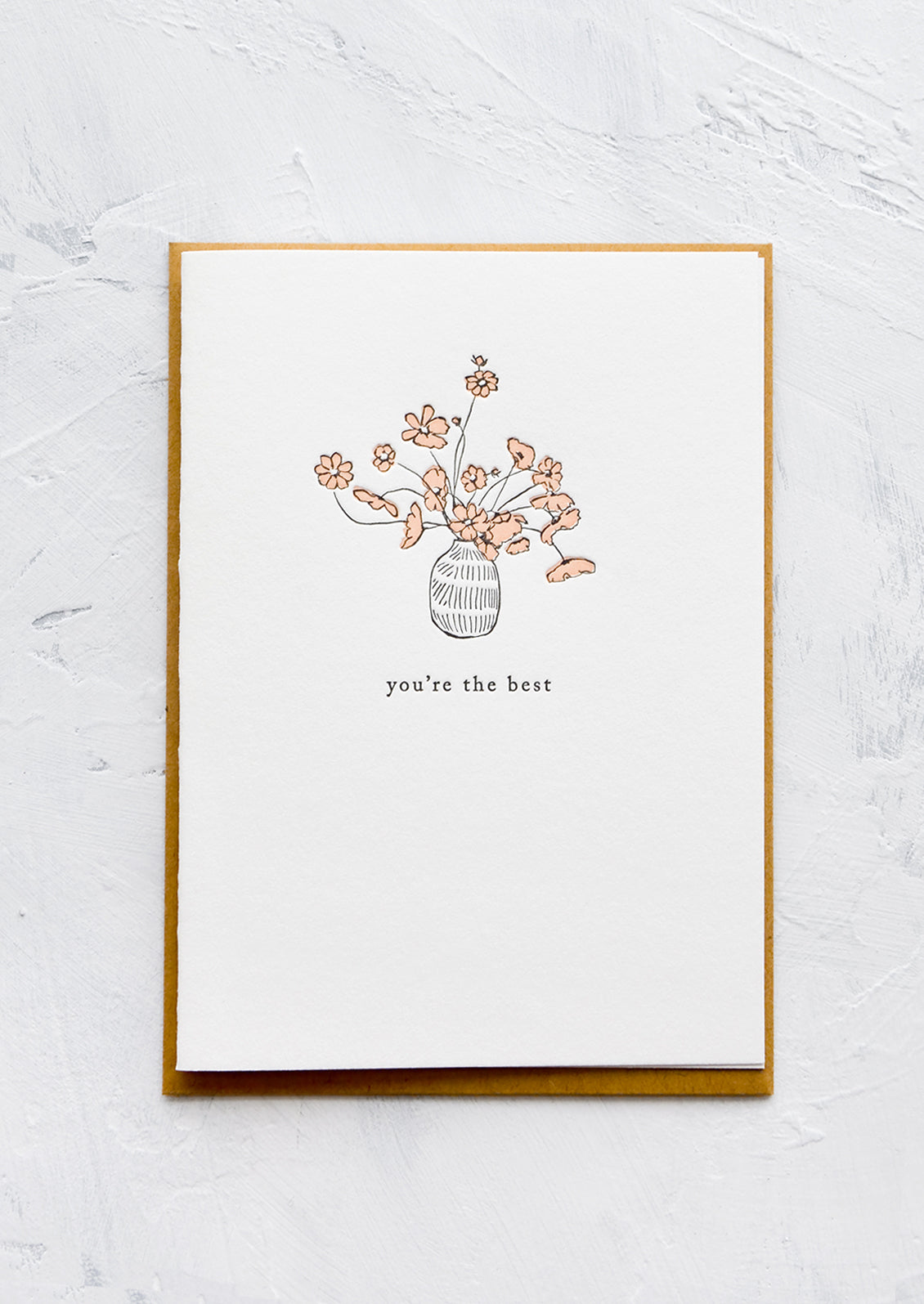 A letterpress printed greeting card with an image of flowers in a vase, text below image reads "you're the best".