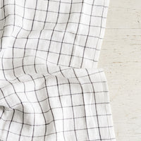 Charcoal Grid: A linen tea towel in white with charcoal grid pattern.