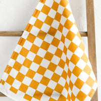 Curry: A checkered linen tea towel in orange and white.