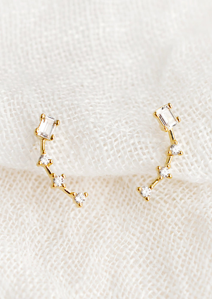 1: A pair of constellation-like gold studs with clear crystal.