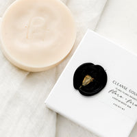 Flora + Fern: A round opaque blush bar soap with wax seal packaging.