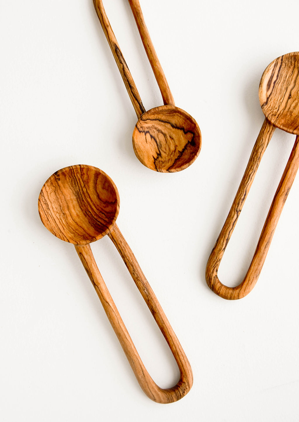 1: Wooden spoons in decorative grained olivewood, with hollow loop-shaped handles