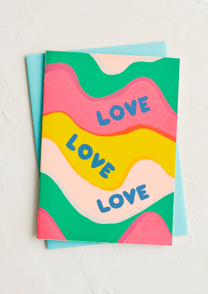 A greeting card with colorful wave pattern reading "LOVE LOVE LOVE".