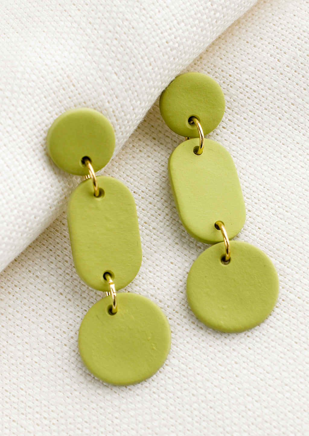 Green Apple: A pair of earrings in three part geometric design in green.
