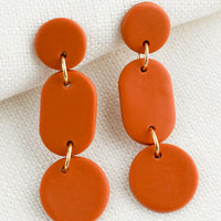 Persimmon: A pair of earrings in three part geometric design in persimmon.