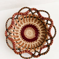 1: A woven basket with swirling, intertwined silhouette.