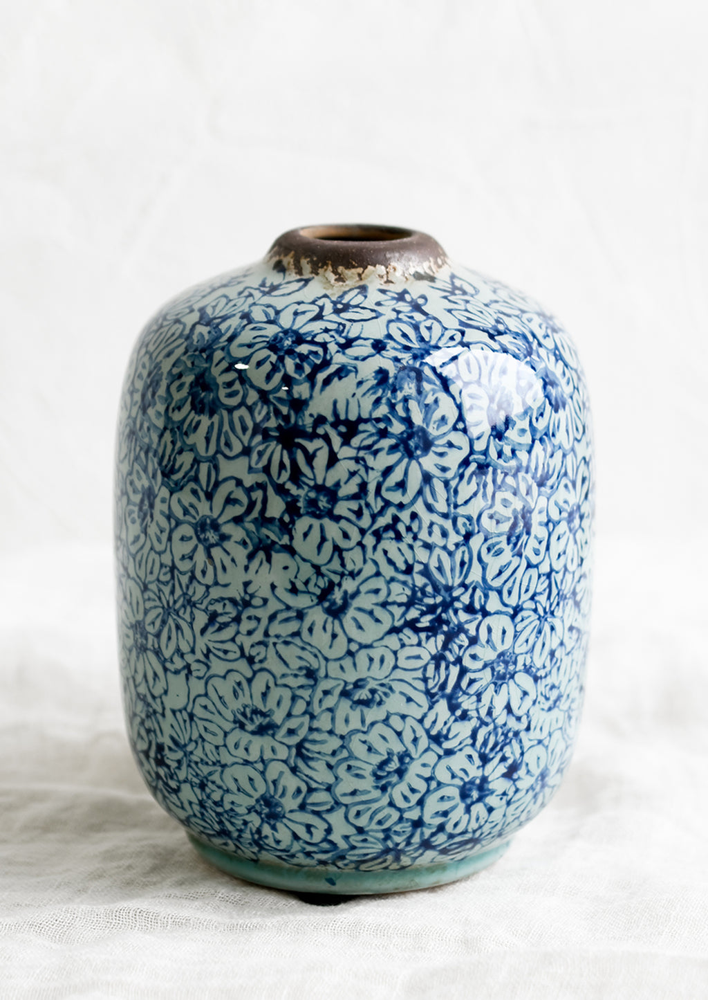 2: A vintage-look ceramic vase with indigo floral pattern.
