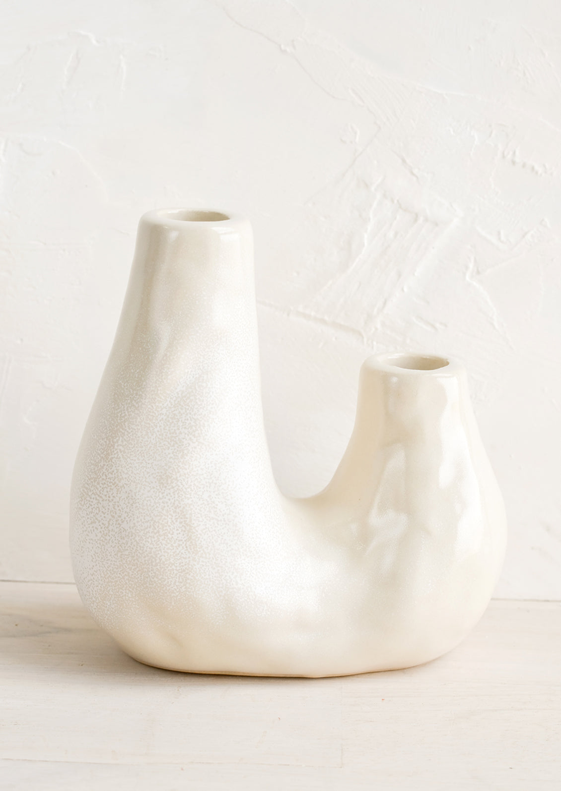 A ceramic 2-taper holder in barnacle-like shape.