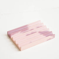 Mauve / Pink: A marbled pale pink and mauve smooth concrete soap dish with troughs and ridges.