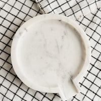1: A round white marble spoon rest.