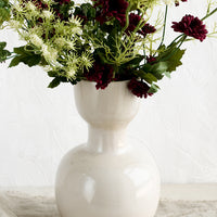 2: A ceramic vase with large arrangement of mixed faux flowers.