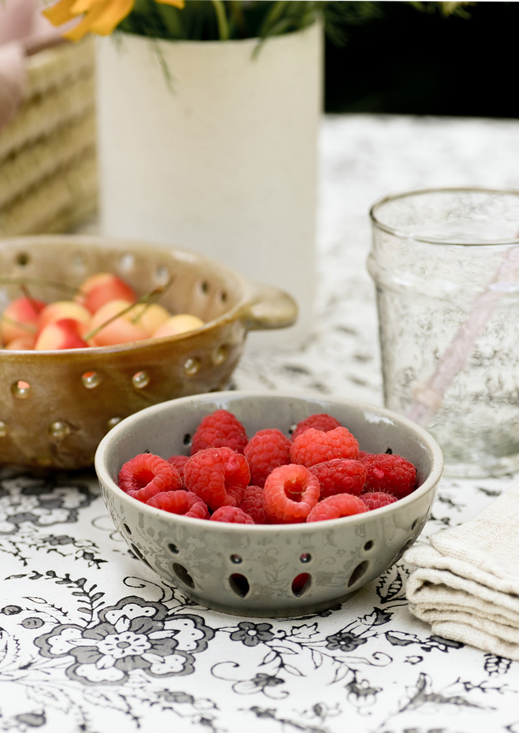 2: A ceramic berry bowl holding raspberries