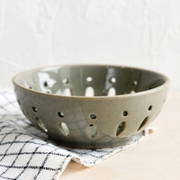Khaki: A ceramic berry bowl with drainage holes in khaki.
