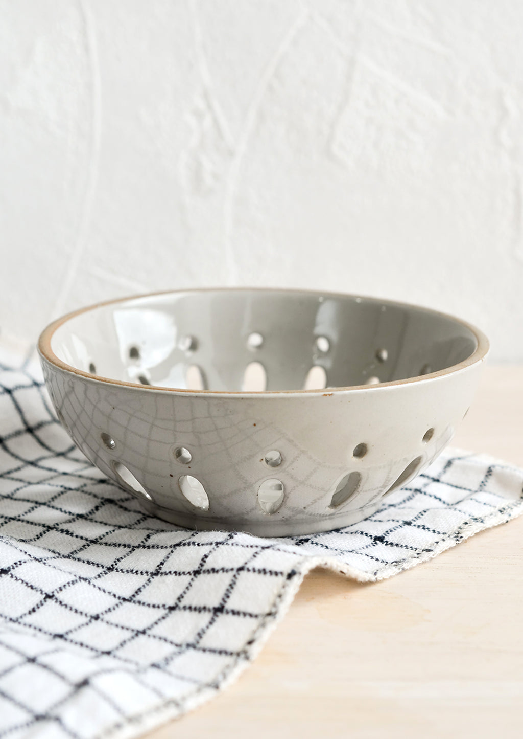 Pale Grey: A ceramic berry bowl with drainage holes in pale grey.