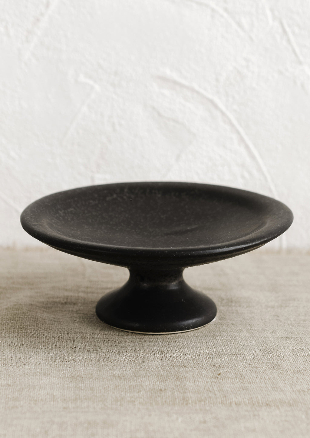 Small / Black: A black ceramic pedestal riser.