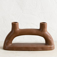 1: A brown ceramic candleholder for two candles.