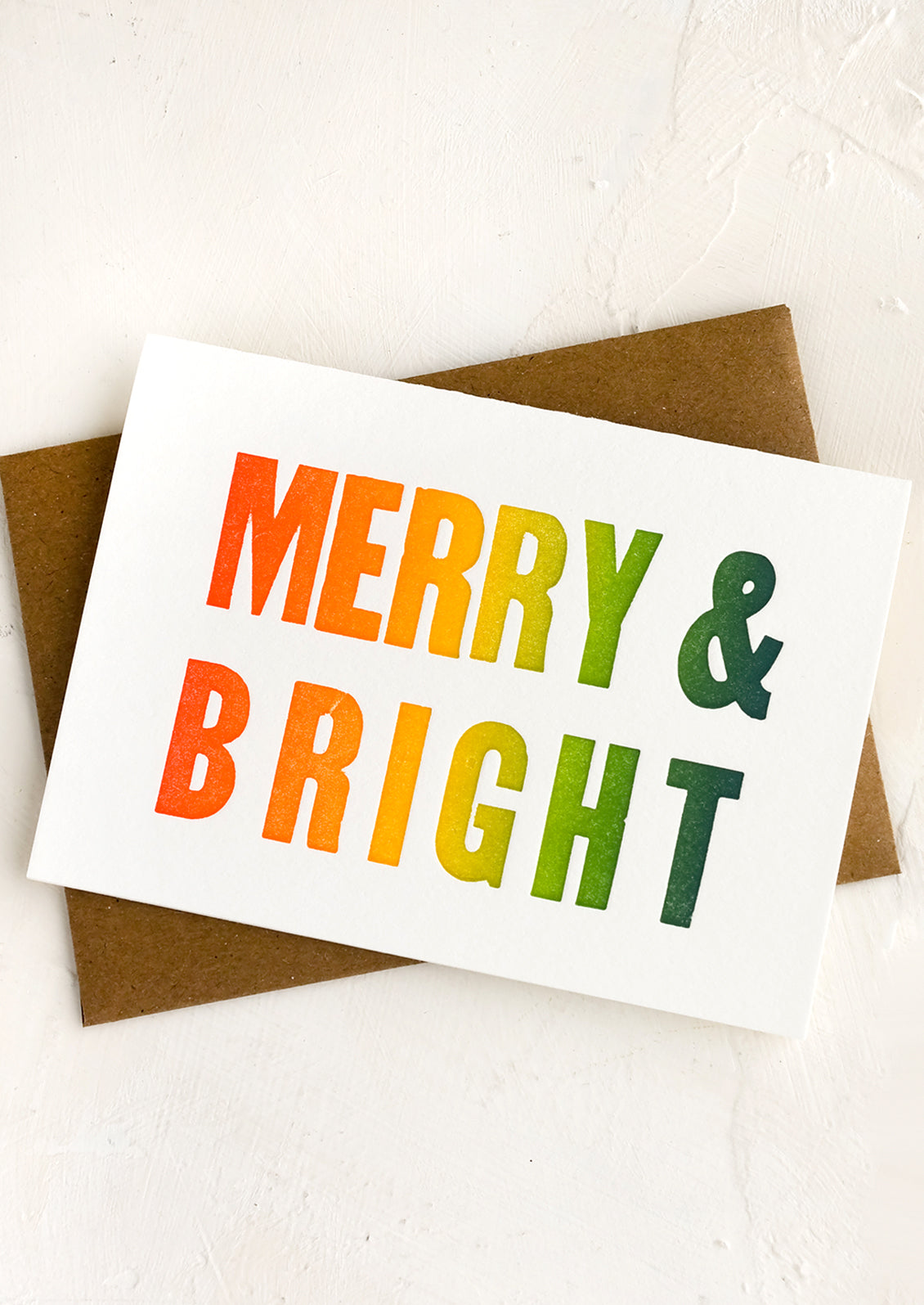 A greeting card with gradient text reading "MERRY & BRIGHT".