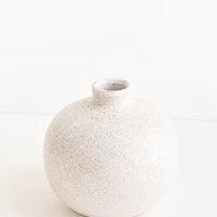 Short [$40.00]: Ceramic vase with bulbous base and narrow opening, in textured light grey glaze