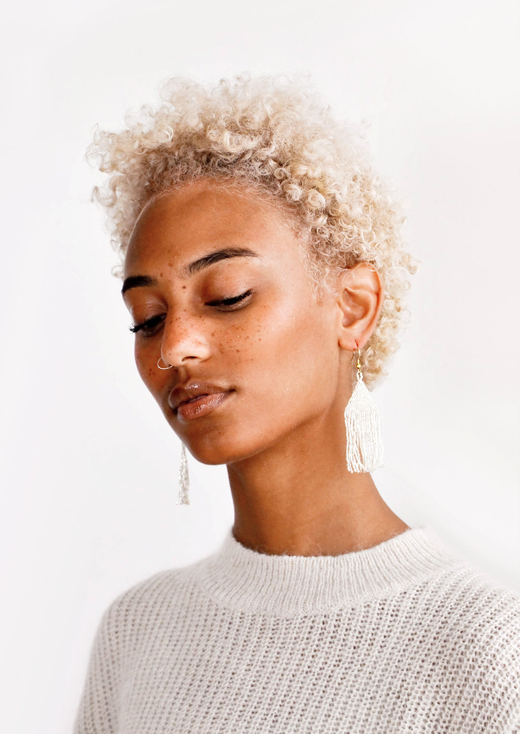 3: Model wears silver fringe beaded earrings and sweater.