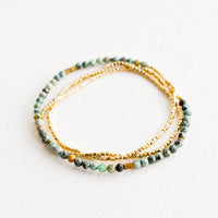 African Turquoise: A single strand bracelet of gold and multi-colored turquoise beads wrapped upon itself in three layers. 