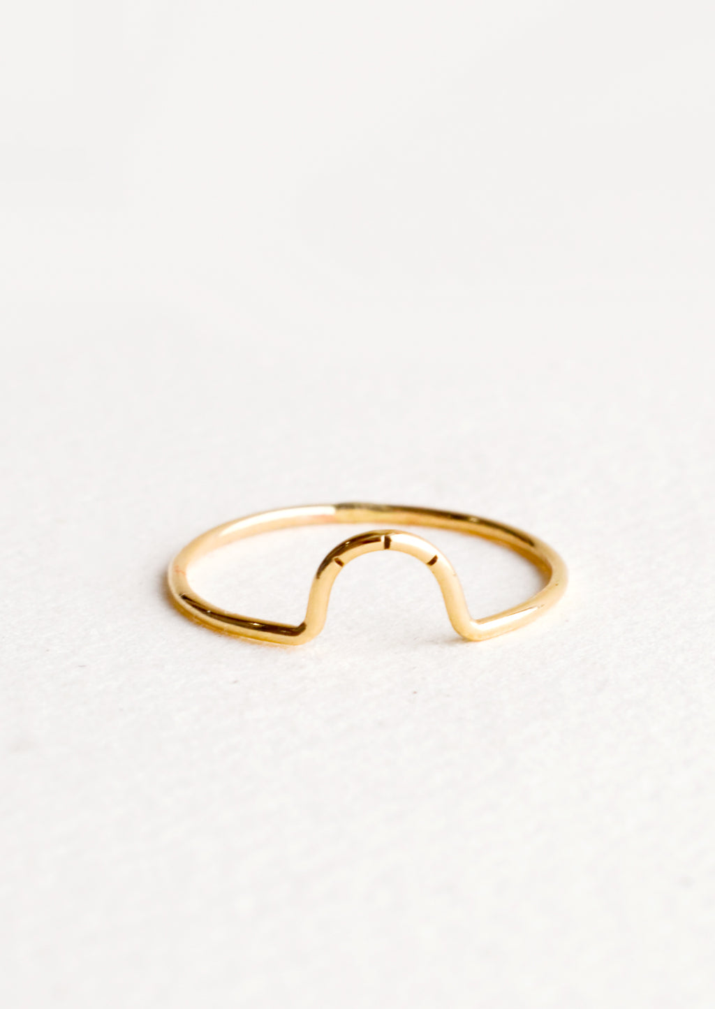 1: Thin gold ring showcasing small arced feature with three etched lines. 