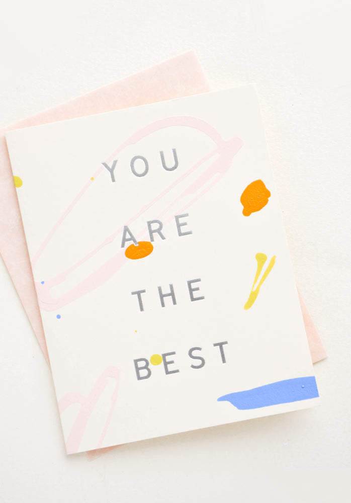1: Greeting card with colored paint strokes and drips, silver lettering reads "You Are The Best"