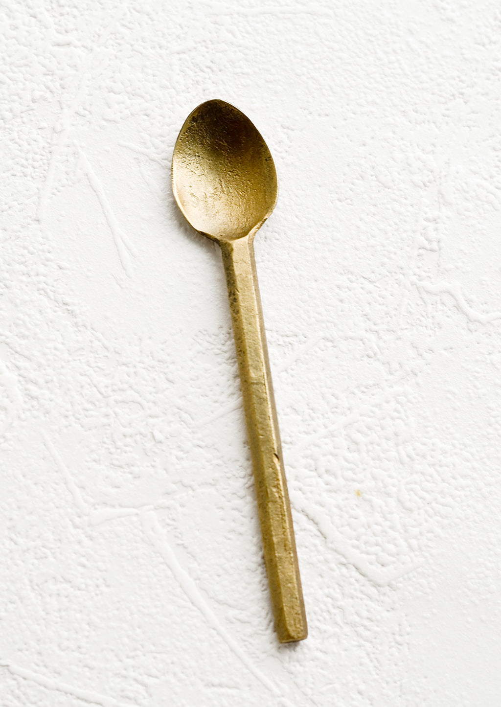 Spoon: A small canape spoon in matte textured brass.