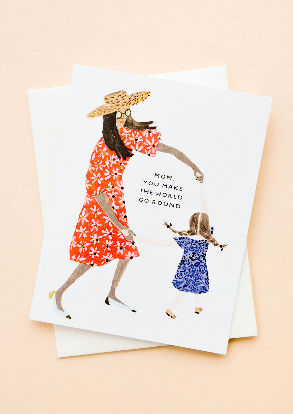 1: Greeting card picturing illustration of mother and child, text reading "Mom, You Make The World Go Round"
