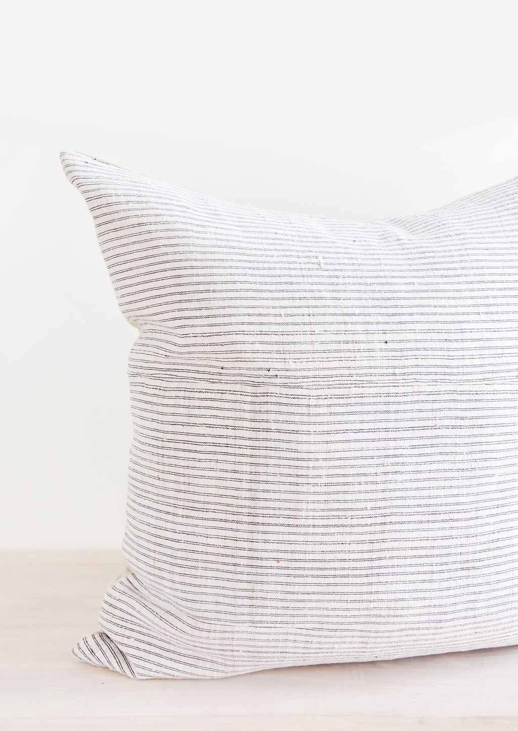 1: Square throw pillow in white hemp fabric with allover thin black stripes
