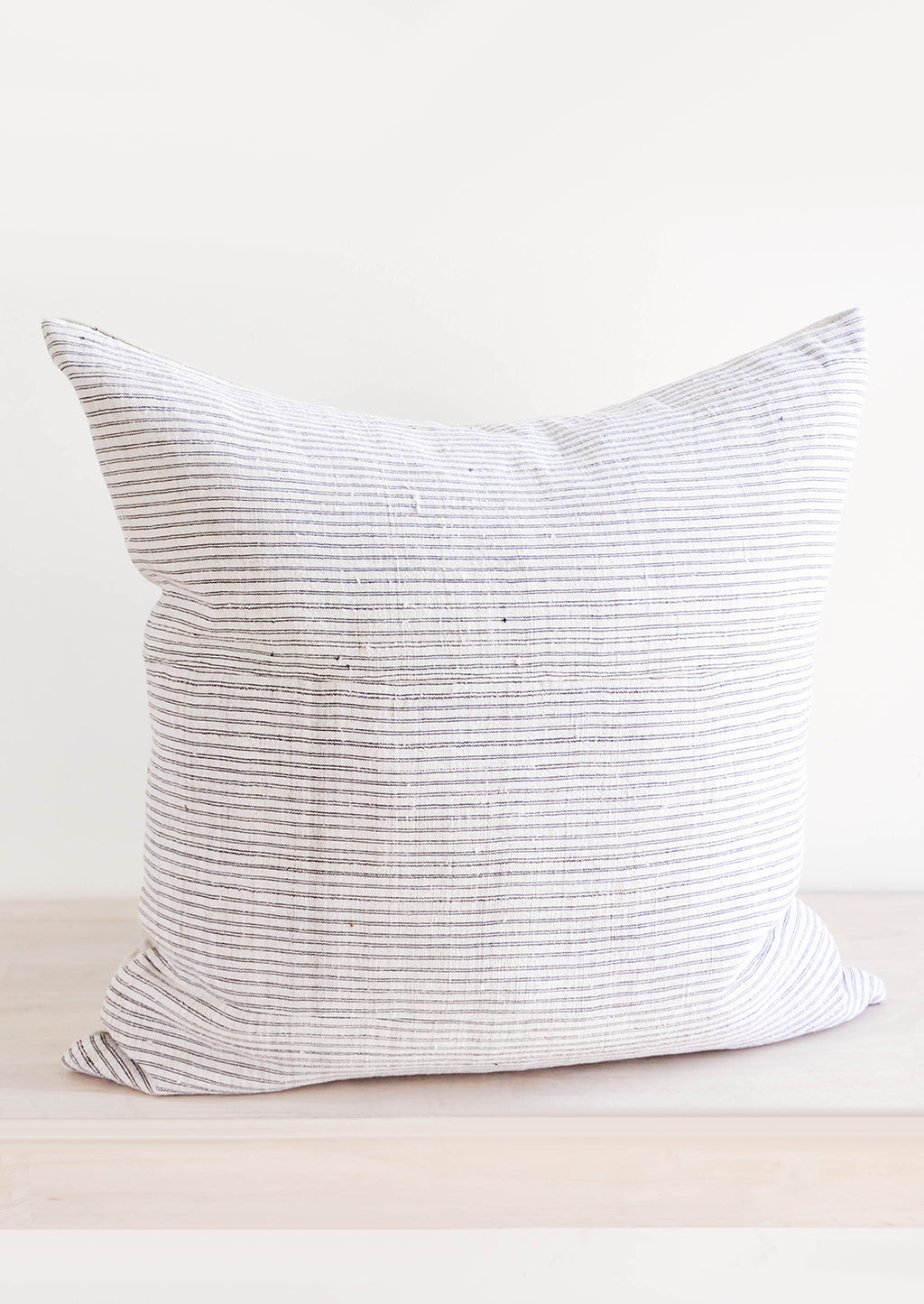 3: Square throw pillow in white hemp fabric with allover thin black stripes