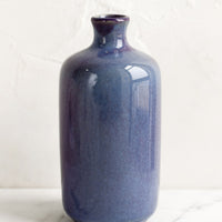 10: A ceramic bud vase in tall shape, blueberry color.