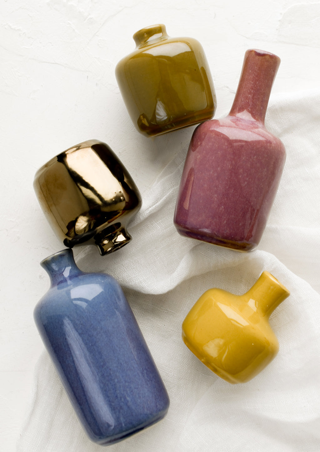 1: Ceramic bud vases in assorted glaze colors.