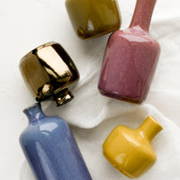 1: Ceramic bud vases in assorted glaze colors.