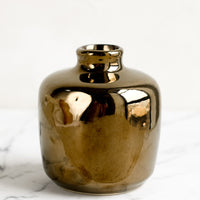 Short / Bronze: A ceramic bud vase in short shape, bronze color.
