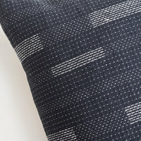 4: Square pillow in black with white variegated stitching in assorted line patterns