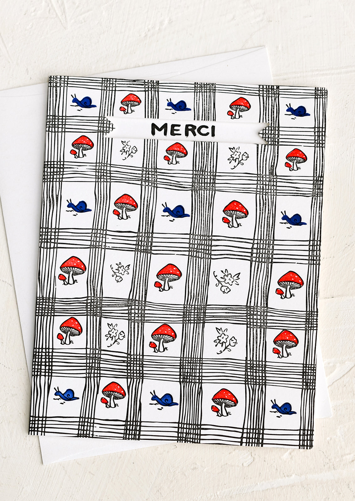A greeting card with mushroom and snail print reading "Merci".