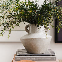 2: A grey vase with eucalyptus.