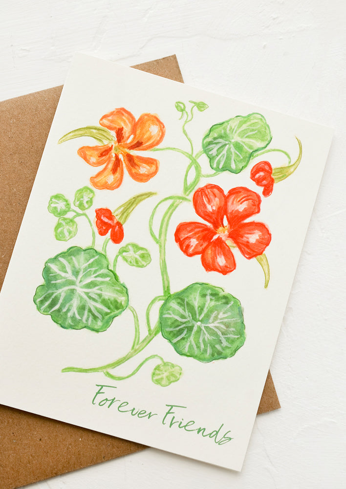 A greeting card with illustration of nasturtiums and green lettering reads "Forever friends".