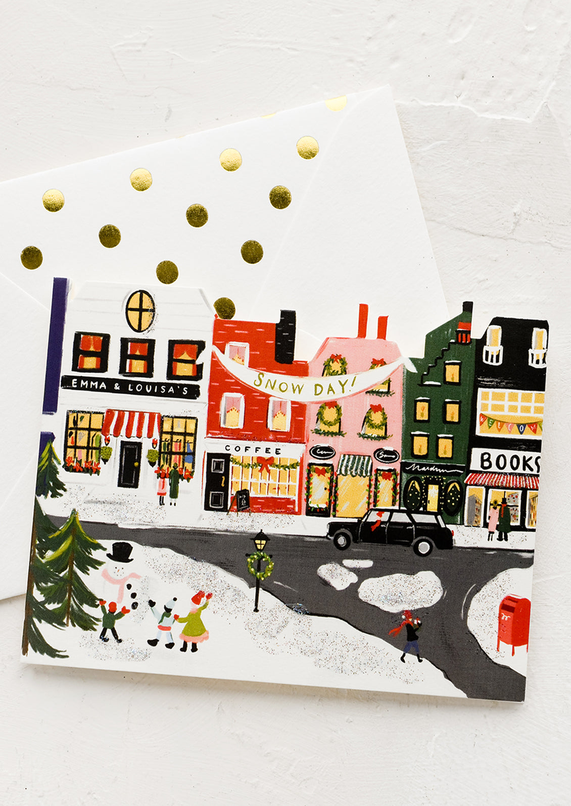 A diecut card of main street town in snow.