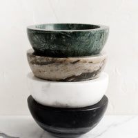1: A stack of four small marble bowls in assorted colors.