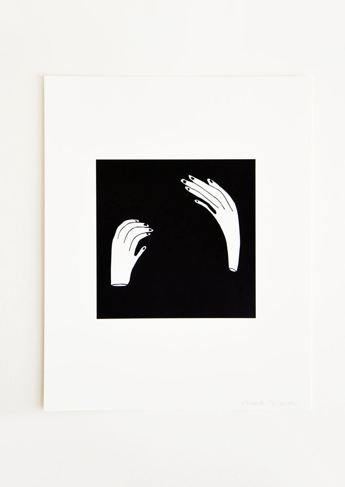 1: Art print with solid black square printed at center, two contorted hands printed in white