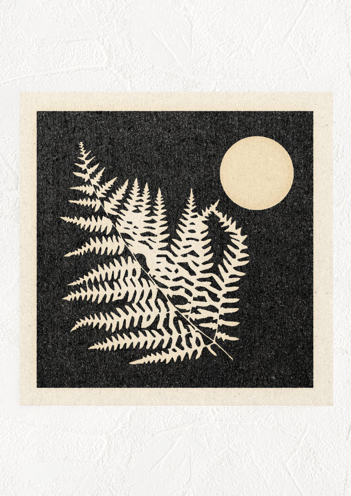 A digital art print with black background and silhouetted fern leaf and moon.