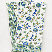 1: A pair of block printed floral napkins in green, blue and orange pattern.