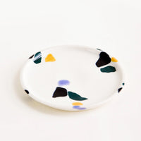 Cool Colors: Small, plate-like ceramic dish in ivory with hand-painted, fragmented pattern in a mix of colors