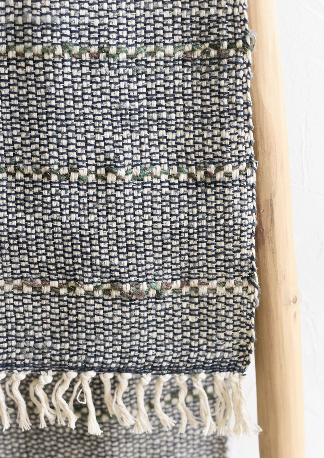 A blue and green table runner with stripe detail.