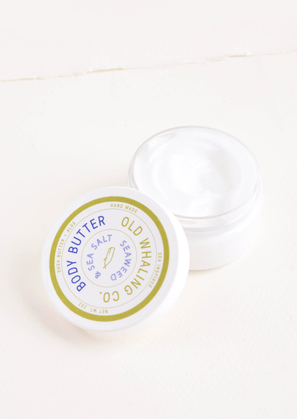 Seaweed & Sea Salt: Round plastic jar of body/hand lotion in seaweed scent