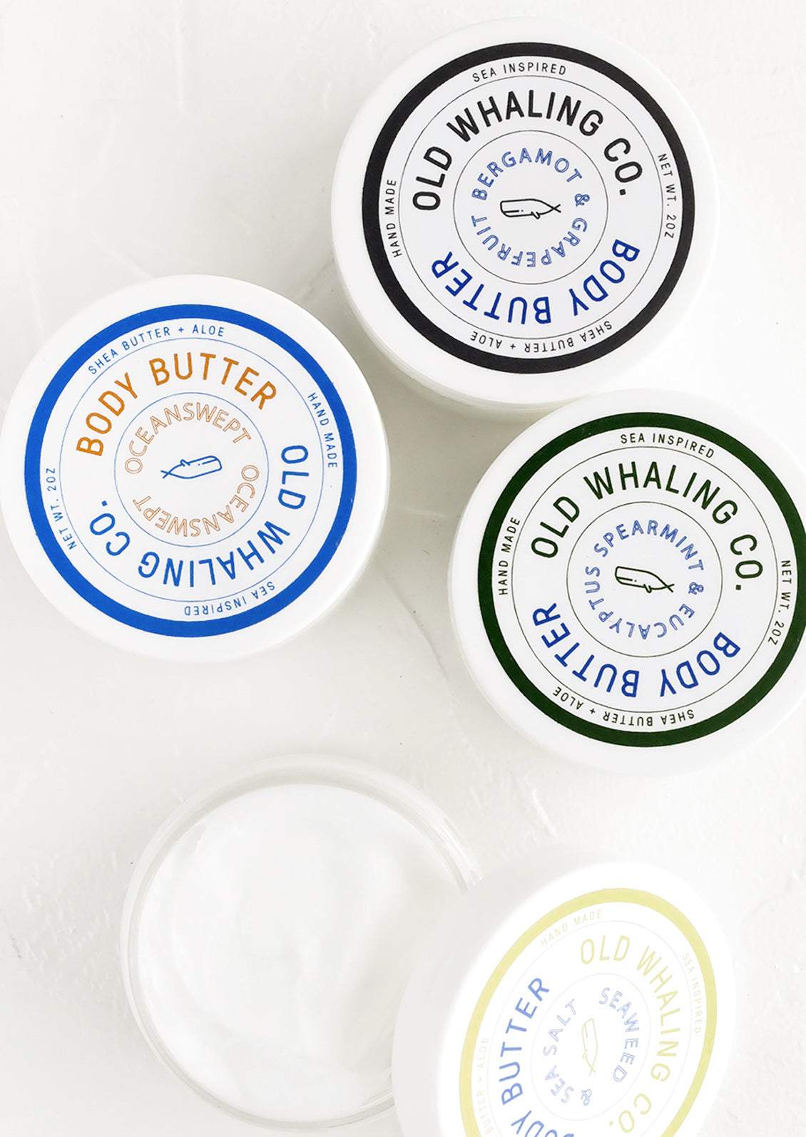 Round plastic jars of body/hand lotion