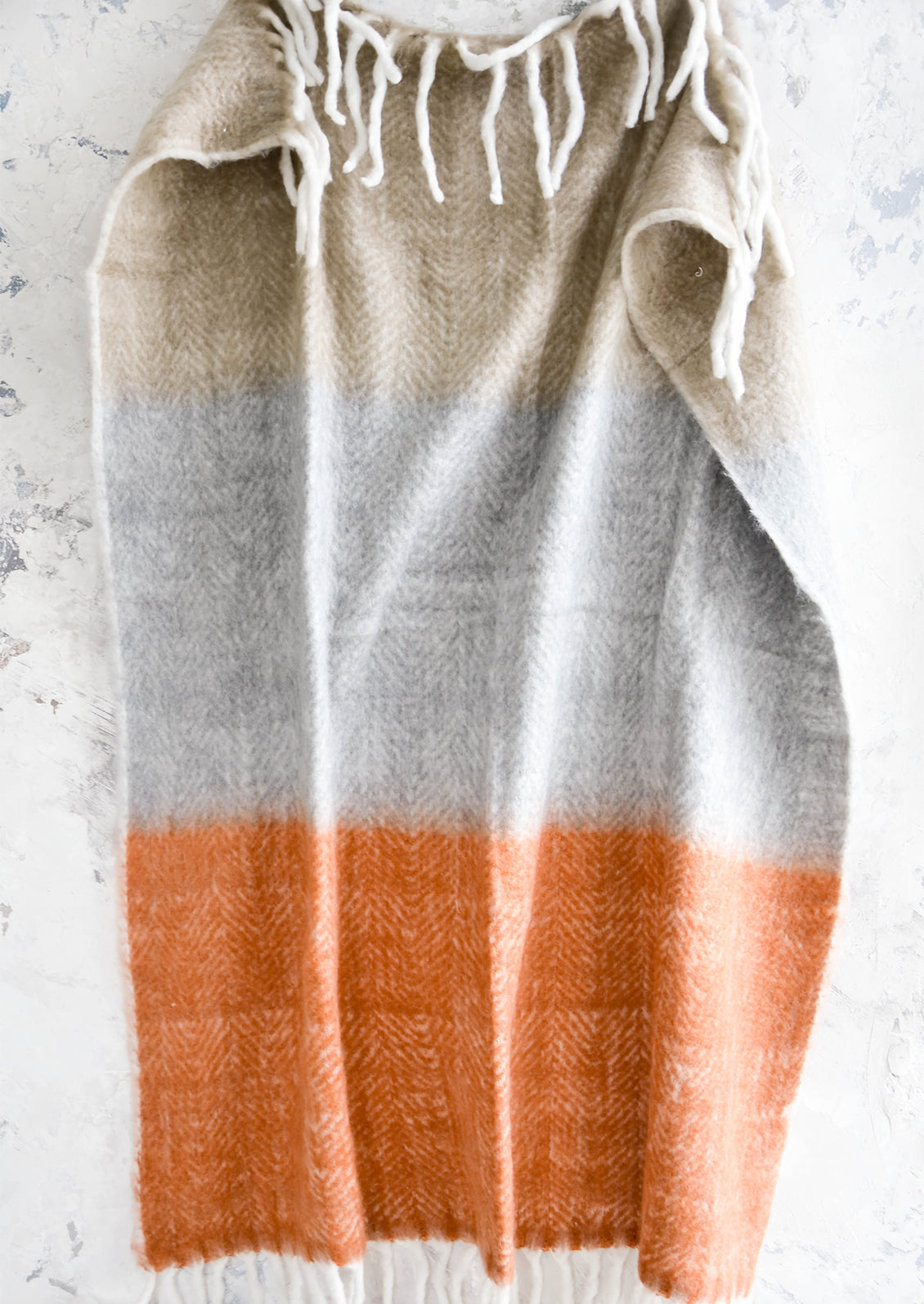 Chunky knit throw blanket in colorblocked design with chunky white fringe trim