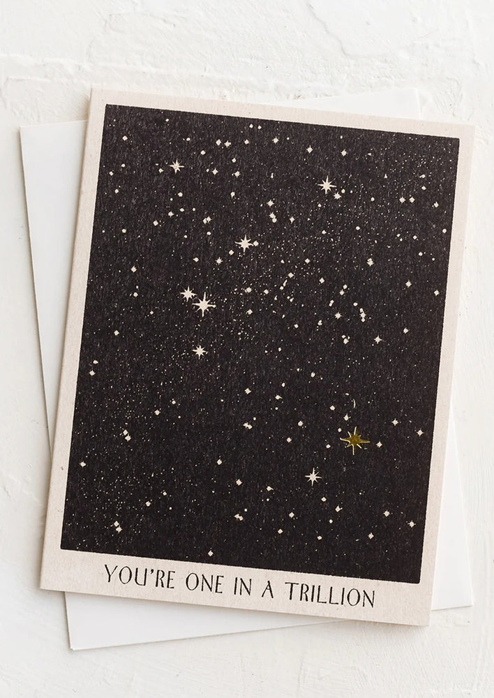 A greeting card with golden star in constellation print.