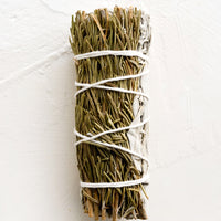 White Sage & Rosemary: A sage smudge stick wrapped in white thread with rosemary.